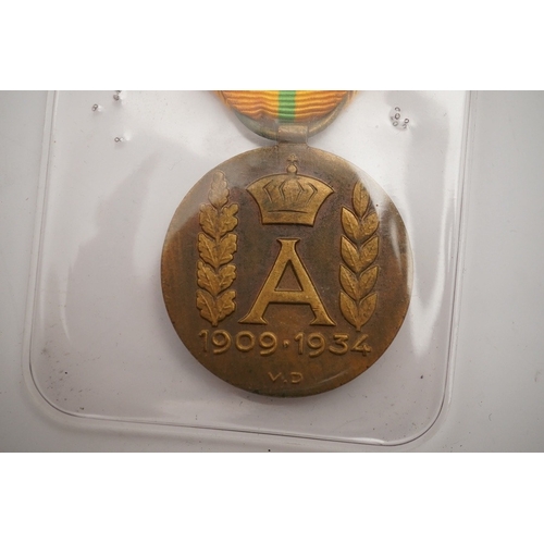 283 - A collection of medal related items, etc., including; a Belgium Albert I commemorative medal,a cased... 