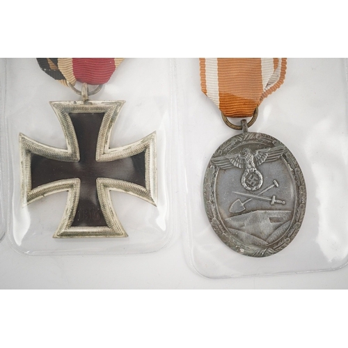 294 - Nine German WWII medals; three Blood Order medals, a Second class Iron Cross, a War Merit medal in i... 