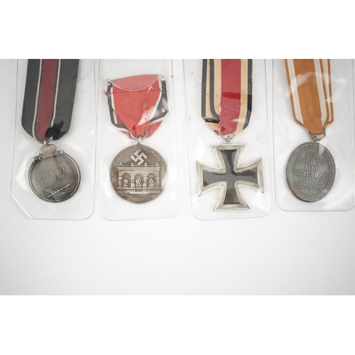 294 - Nine German WWII medals; three Blood Order medals, a Second class Iron Cross, a War Merit medal in i... 