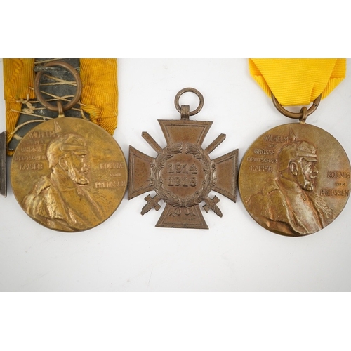 297 - Five German WWI medals; two Second class Iron Crosses, two Kaiser Wilhelm Centenary medals and an Ho... 