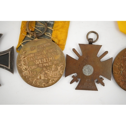 297 - Five German WWI medals; two Second class Iron Crosses, two Kaiser Wilhelm Centenary medals and an Ho... 