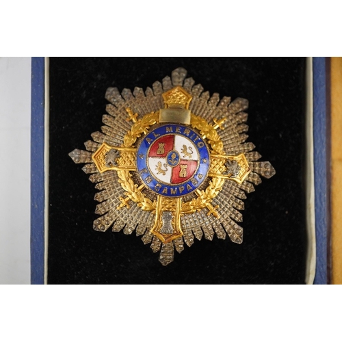 316 - Two cased World War II medals; a Spanish 'Grand Cross of Al Merito En Campana', ('Order of Merit in ... 