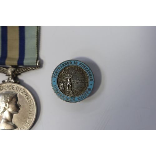 342 - An ERII (B) Royal Observer Corps medal to Observer W.Cook with a lapel badge. Condition - fair.... 