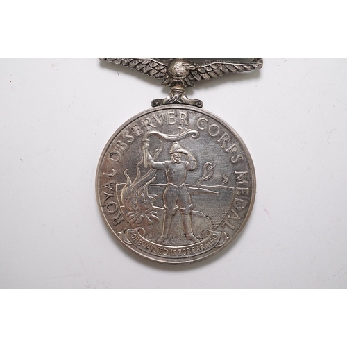 342 - An ERII (B) Royal Observer Corps medal to Observer W.Cook with a lapel badge. Condition - fair.... 