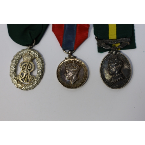 350 - Three assorted service medals; Ed VII Volunteer Officer's Decoration hallmarked for 1905; GV Imperia... 