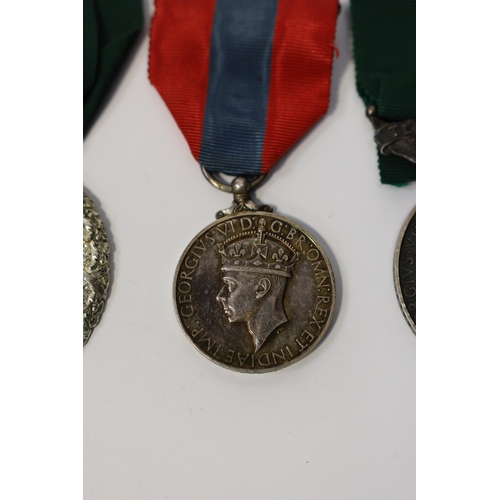 350 - Three assorted service medals; Ed VII Volunteer Officer's Decoration hallmarked for 1905; GV Imperia... 