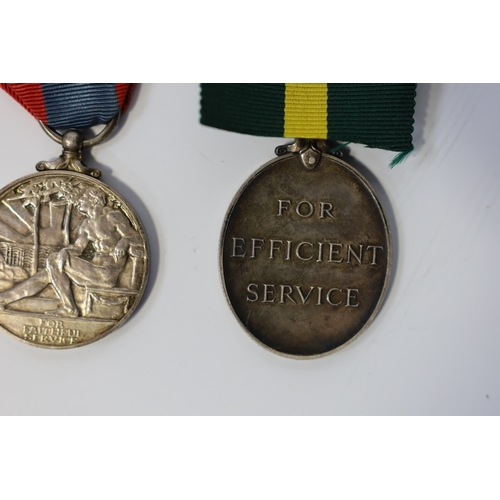 350 - Three assorted service medals; Ed VII Volunteer Officer's Decoration hallmarked for 1905; GV Imperia... 