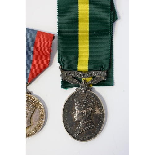 350 - Three assorted service medals; Ed VII Volunteer Officer's Decoration hallmarked for 1905; GV Imperia... 