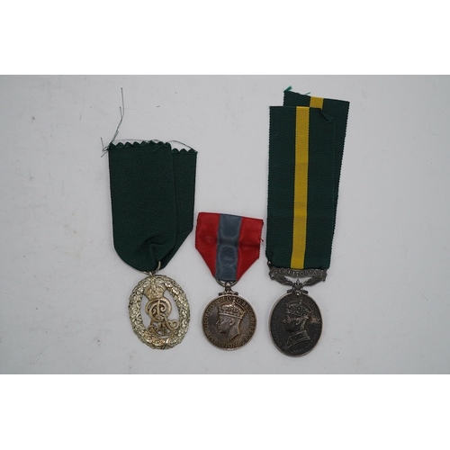 350 - Three assorted service medals; Ed VII Volunteer Officer's Decoration hallmarked for 1905; GV Imperia... 