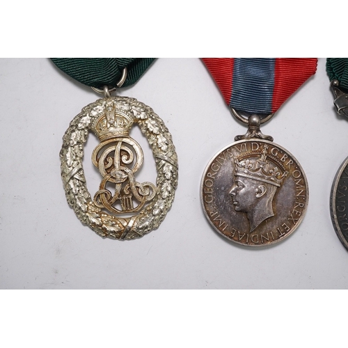 350 - Three assorted service medals; Ed VII Volunteer Officer's Decoration hallmarked for 1905; GV Imperia... 