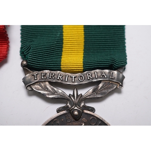 350 - Three assorted service medals; Ed VII Volunteer Officer's Decoration hallmarked for 1905; GV Imperia... 