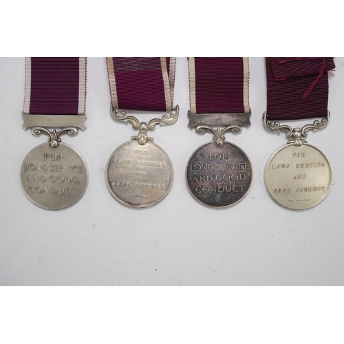 352 - Four Army Long Service and Good Conduct medals; Vict to 21579 Gunr A.Milln. R.A.; GV to 1404425 B.Q.... 