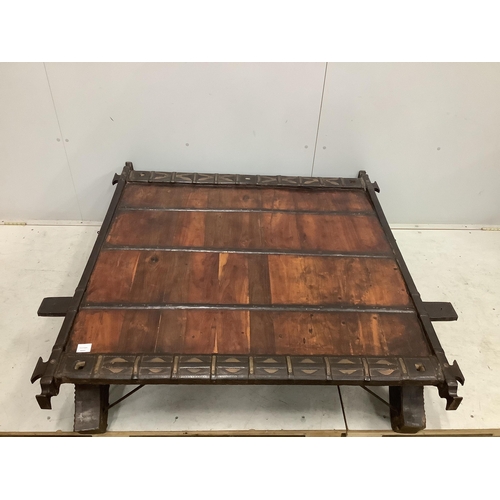 39 - An Indian hardwood and iron mounted low square table, width 138cm, depth 130cm, height 33cm. Conditi... 