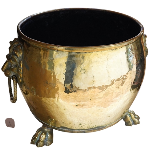 410 - A large Victorian brass log bucket with lions head handles and paw feet, 50cm in diameter. Condition... 