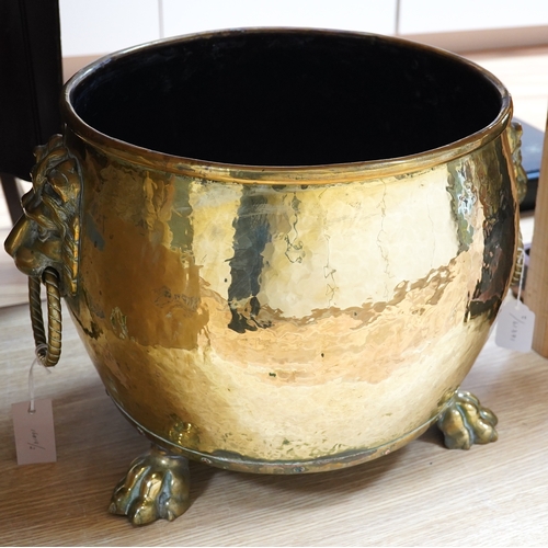 410 - A large Victorian brass log bucket with lions head handles and paw feet, 50cm in diameter. Condition... 