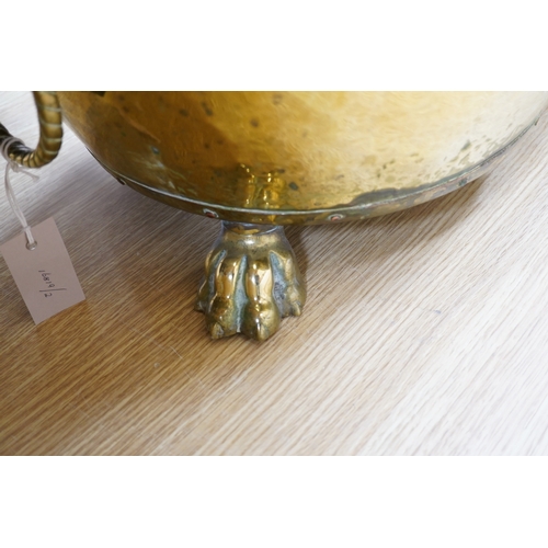 410 - A large Victorian brass log bucket with lions head handles and paw feet, 50cm in diameter. Condition... 