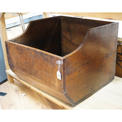 413 - An early 20th century oak dog basket, 65cm wide. Condition - fair