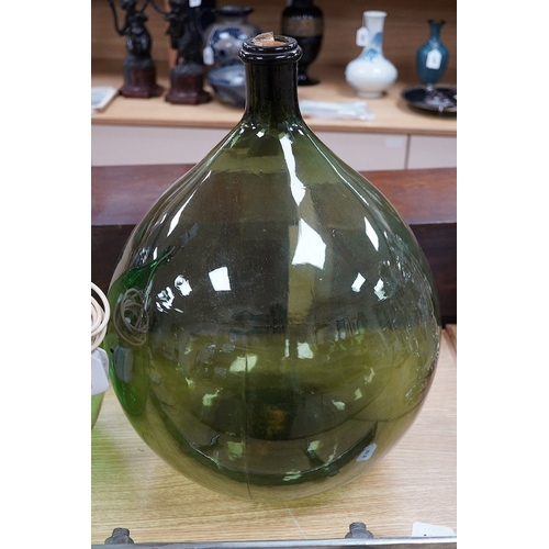 416 - Two green glass carboys, one converted to a lamp, 58cm high overall. Condition - good, untested... 