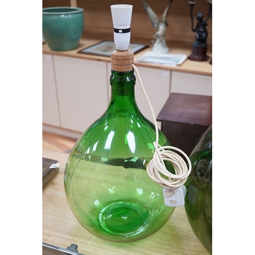 416 - Two green glass carboys, one converted to a lamp, 58cm high overall. Condition - good, untested... 