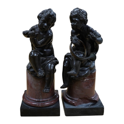 422 - A pair of 19th century French bronze figures of children playing instruments, raised on rouge marble... 