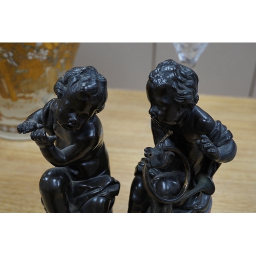 422 - A pair of 19th century French bronze figures of children playing instruments, raised on rouge marble... 