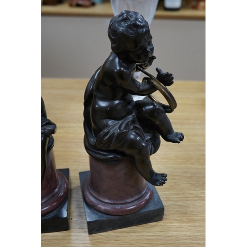 422 - A pair of 19th century French bronze figures of children playing instruments, raised on rouge marble... 