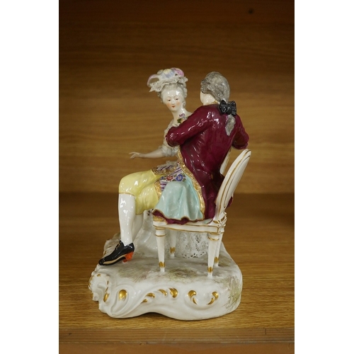 440 - A Sitzendorf tete-a-tete porcelain figure group, signed to the base, 21cm high. Condition - fair, so... 