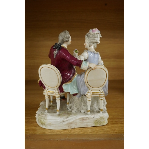 440 - A Sitzendorf tete-a-tete porcelain figure group, signed to the base, 21cm high. Condition - fair, so... 