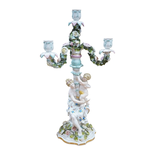 446 - A French porcelain floral encrusted three branch candelabra, 51cm. Condition - poor