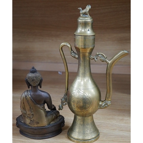 490 - A South East Asian bronze Buddha and an engraved brass wine ewer, 39cm high. Condition - good