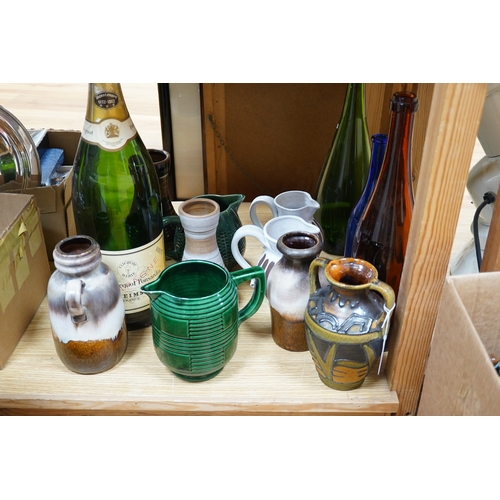 498 - A collection of studio pottery and four glass bottles to include an oversized advertising bottle of ... 