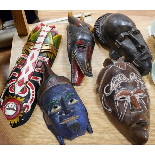 501 - Five various tribal masks and a chip carved panel, 100x45cm. Condition - good