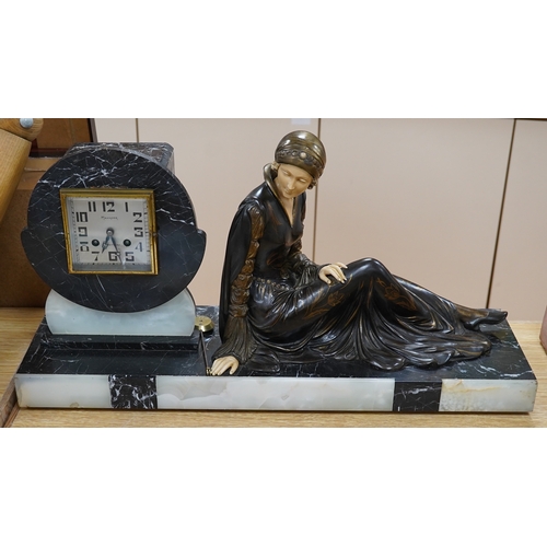 509 - A French Art Deco black and white marble clock, with an ornately painted Spelter figure of a seated ... 