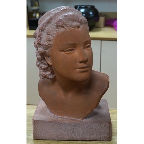 512 - A terracotta bust of a young woman, signed U Cipriani, 37cm high. Condition - good