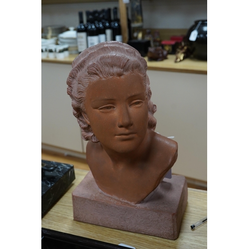 512 - A terracotta bust of a young woman, signed U Cipriani, 37cm high. Condition - good