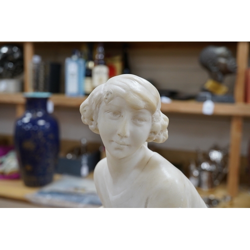 519 - A French 1920s-30s alabaster sculpture of a lady seated on a stone wall, sculpture mounted on a ma... 