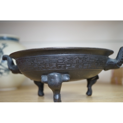 521 - A Chinese archaistic bronze tripod elephant head censer, Xuande mark, 19th century, 24cm handle to... 