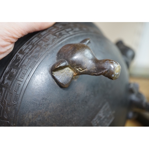 521 - A Chinese archaistic bronze tripod elephant head censer, Xuande mark, 19th century, 24cm handle to... 