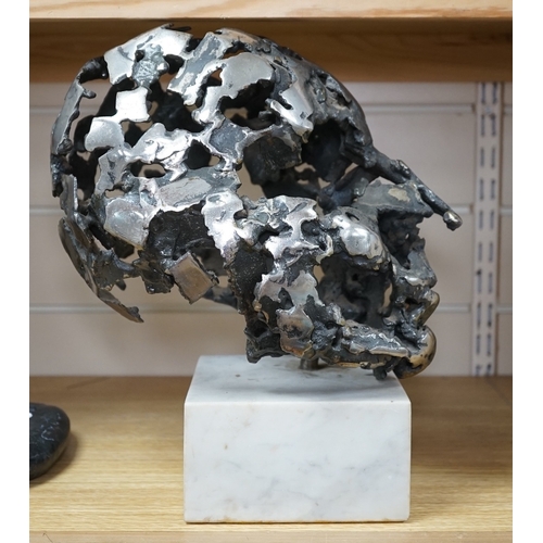 529 - A modern polished steel skull, pierced and mounted on square white marble plinth, circa 1975, 31cm h... 