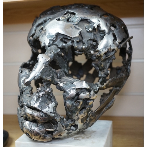 529 - A modern polished steel skull, pierced and mounted on square white marble plinth, circa 1975, 31cm h... 