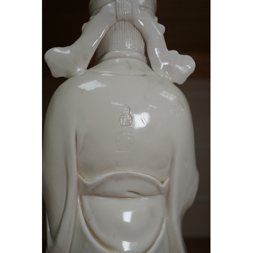 543 - A Chinese blanc de chine Buddha figure, stamped to the reverse, 30cm high. Condition - Good