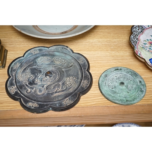 545 - A Chinese archaistic bronze bell, two bronze mirrors, a bronze figure of Nandi, a kitchen Qing dish,... 