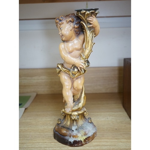 552 - An Austrian carved and partially gilt cherub pricket candlestick, 37cm high. Condition - fair to goo... 