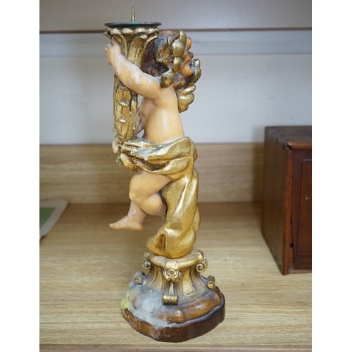 552 - An Austrian carved and partially gilt cherub pricket candlestick, 37cm high. Condition - fair to goo... 