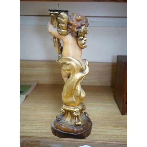 552 - An Austrian carved and partially gilt cherub pricket candlestick, 37cm high. Condition - fair to goo... 