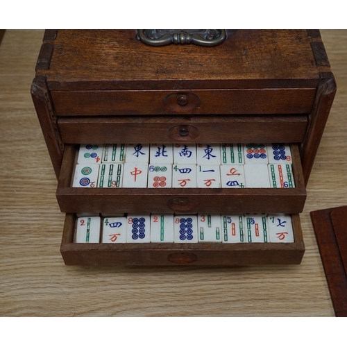 553 - A Chinese boxed bone Mah jong set with five drawers, 19cm high. Condition - poor to fair, case damag... 