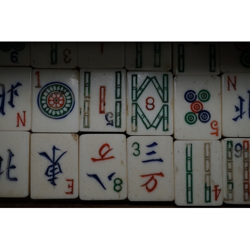 553 - A Chinese boxed bone Mah jong set with five drawers, 19cm high. Condition - poor to fair, case damag... 