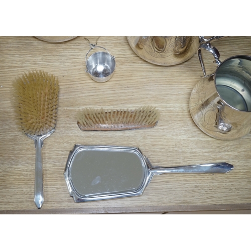 562 - An Art Deco three piece silver brush set and a silver plated three piece tea set and miniature caldr... 