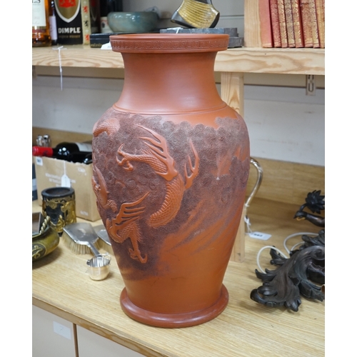 563 - A large Japanese terracotta dragon decorated vase, 50cm high. Condition - hole drilled to base... 