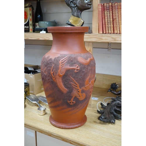 563 - A large Japanese terracotta dragon decorated vase, 50cm high. Condition - hole drilled to base... 